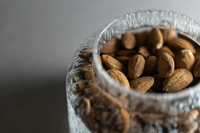 brown coffee beans in clear glass jar