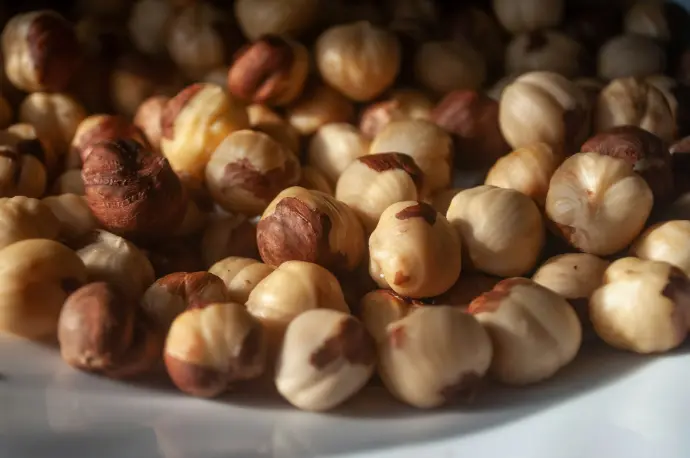 a white plate topped with nuts on top of a table